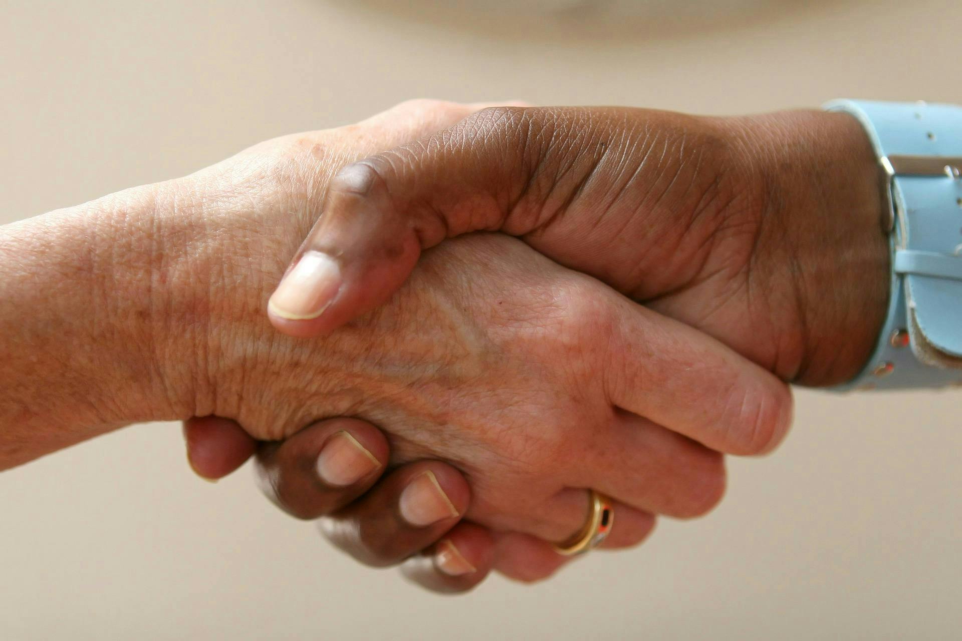 Close up image of a handshake between two people.