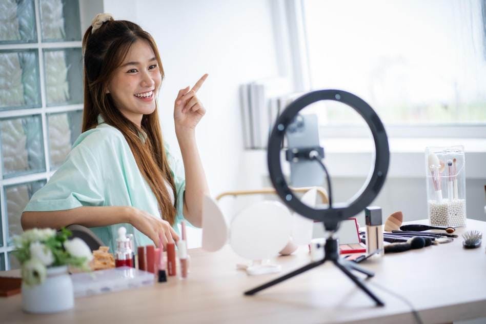 influencer creating video content in front of a ring light