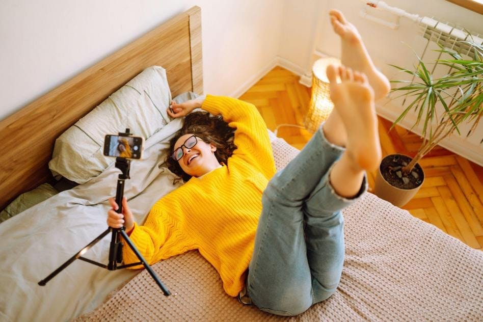 girl filming new content on her bed