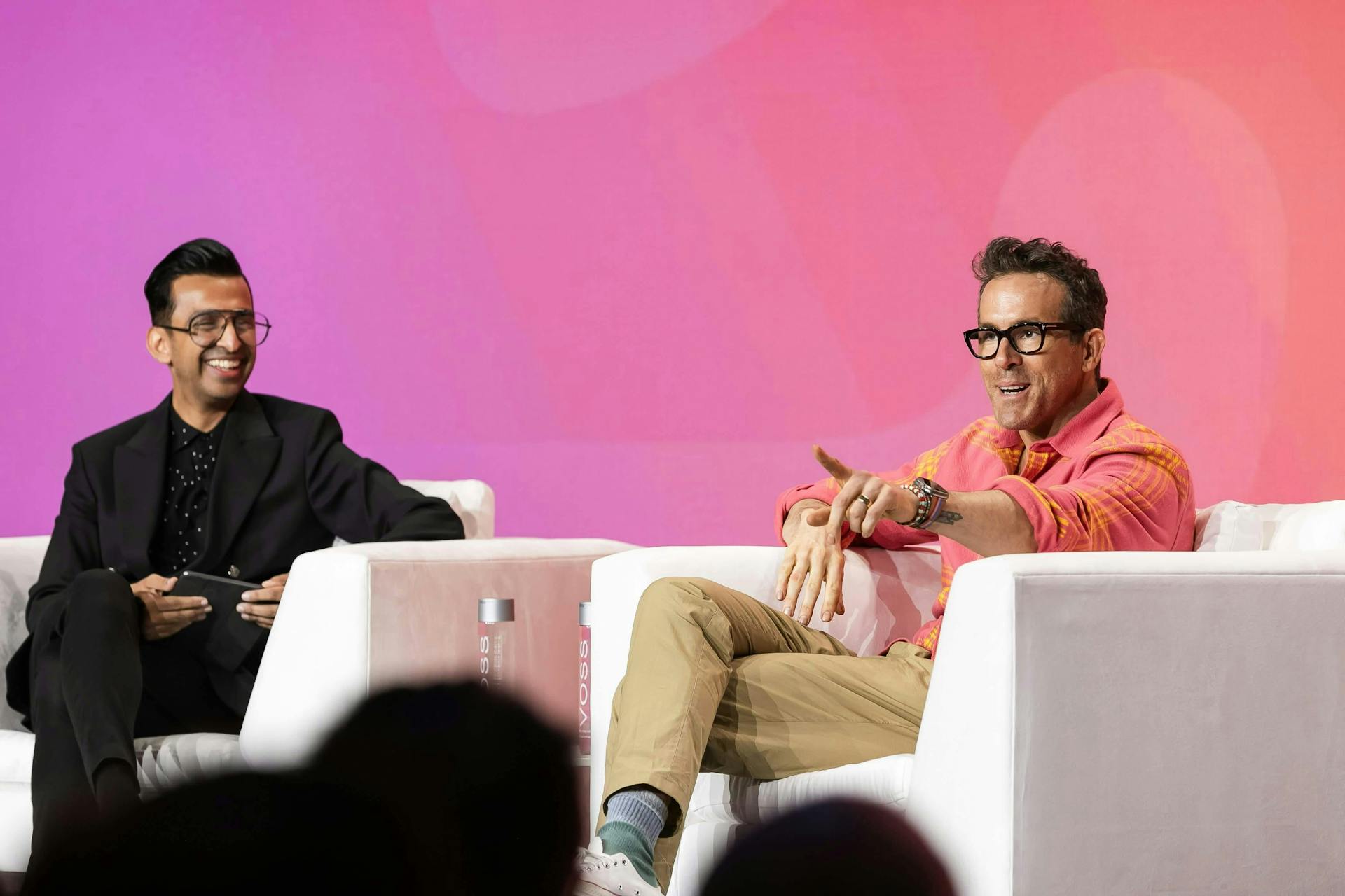 Actor and entrepreneur Ryan Reynolds seated onstage with Meltwater VP of Culture Zubair Timol at Meltwater Summit 2024.