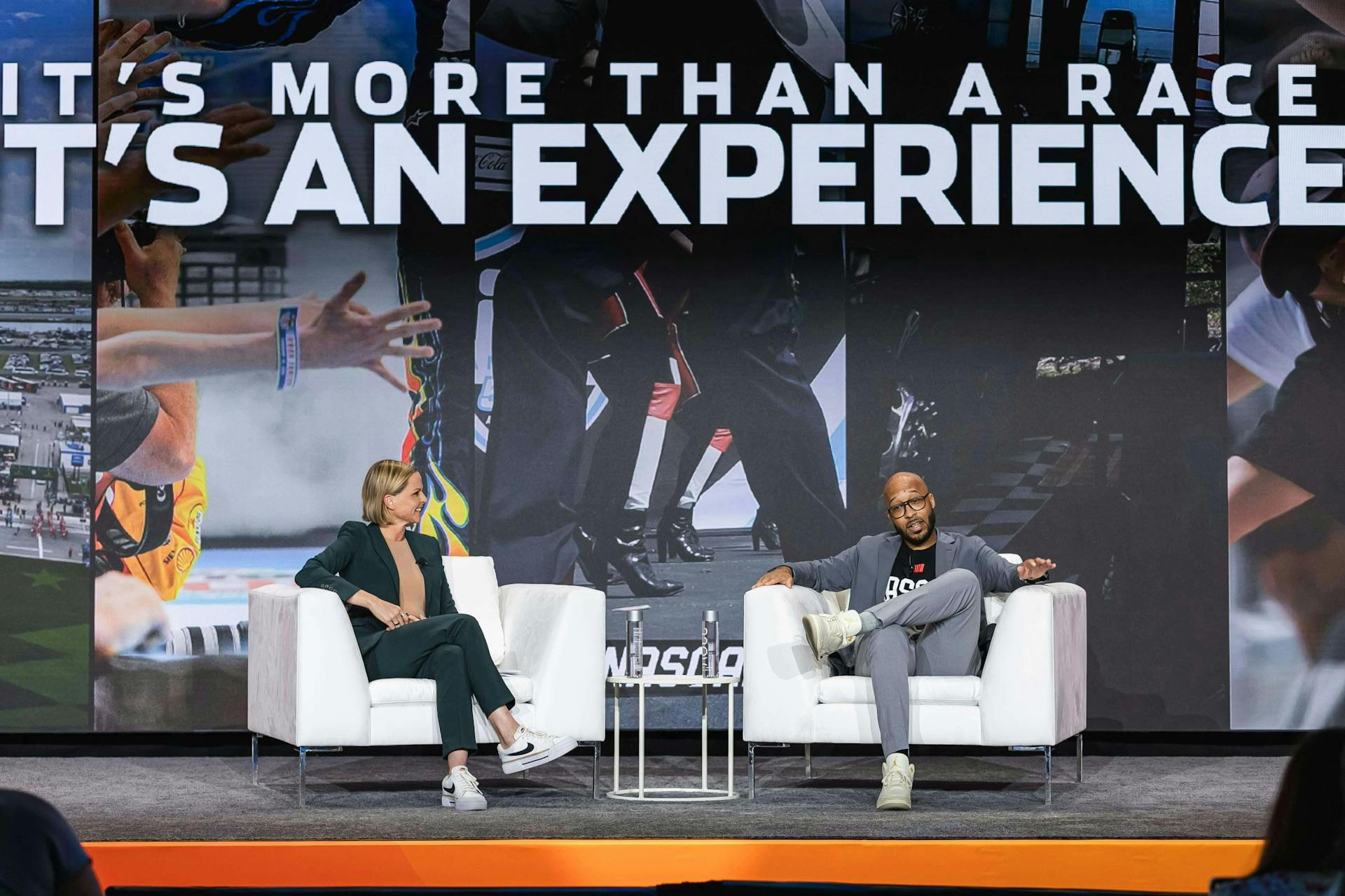 NASCAR VP of Communications Eric Ryan onstage with sportscaster Shannon Spake during Meltwater Summit 2024