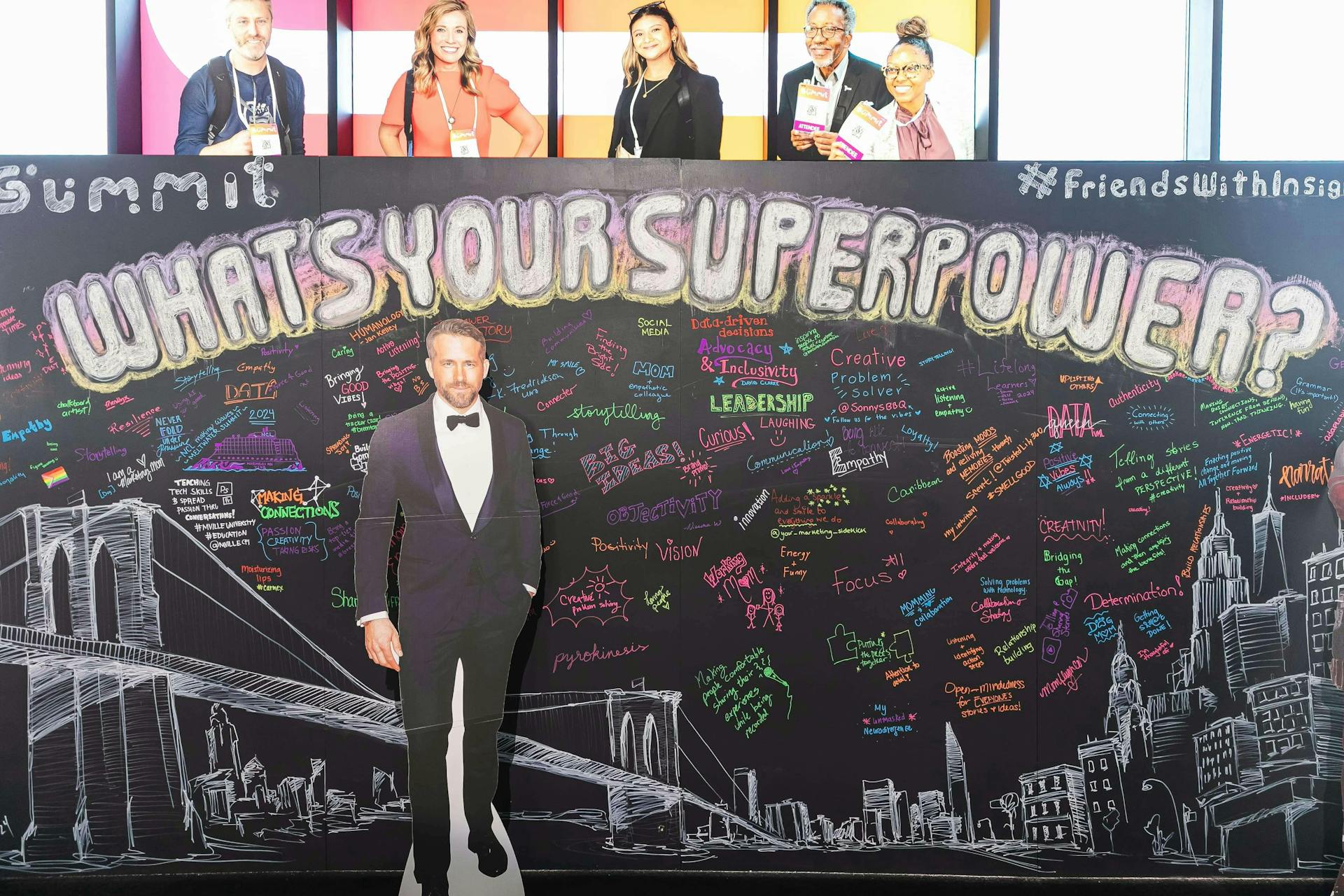 Image of the chalkboard wall activation at Meltwater Summit 2024, featuring the prompt What's Your Superpower? and a cardboard cutout of Ryan Reynolds