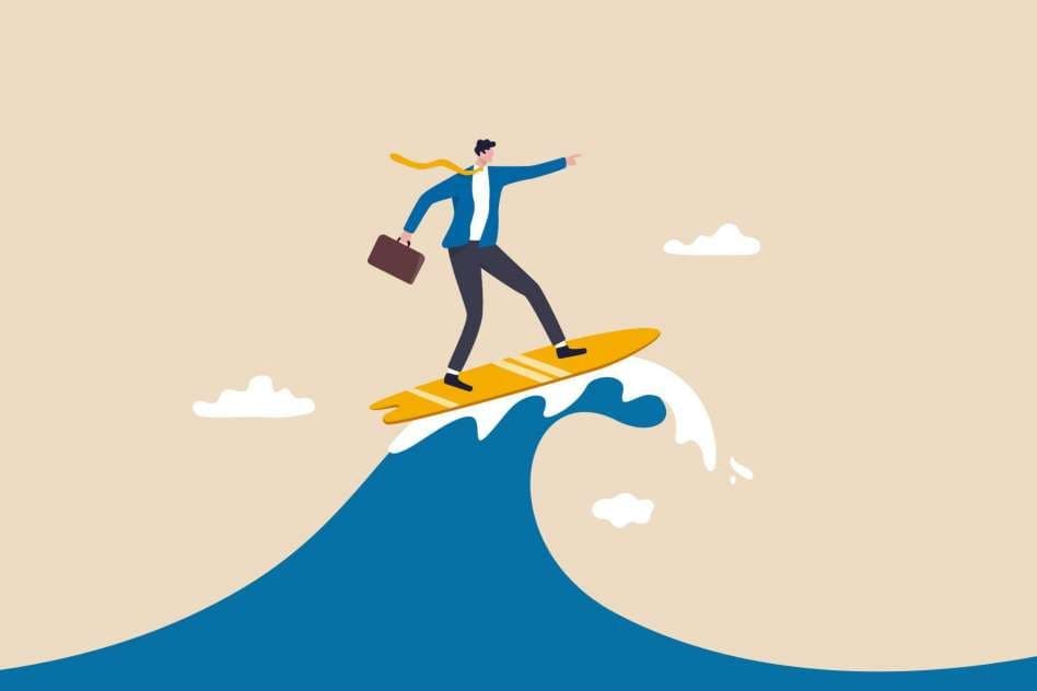 business man in a suit riding a wave