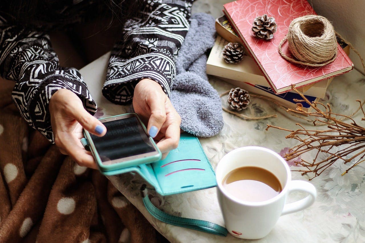 Person using a smartphone to make a social media post