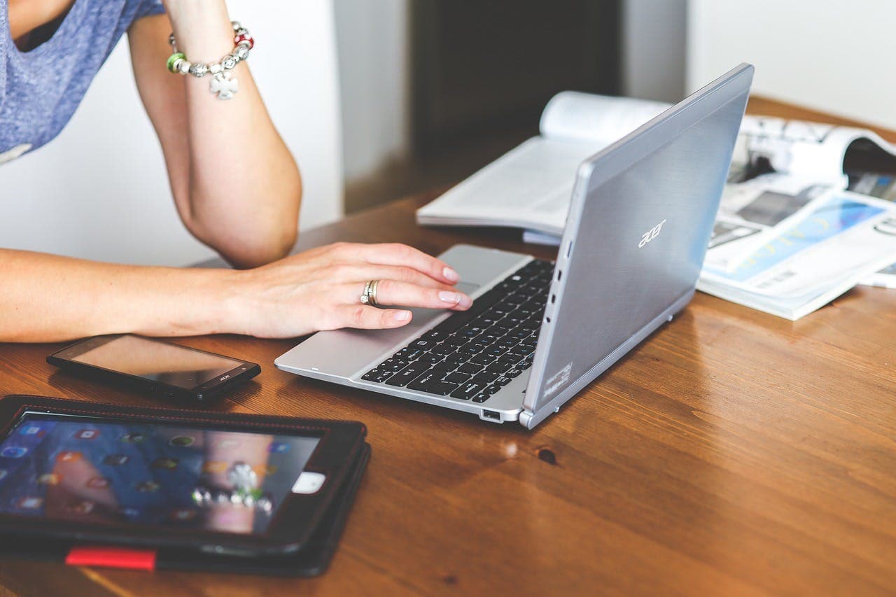  Person sitting at a desk with a laptop, sending emails for a marketing lead generation campaign